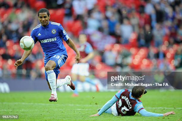 Florent Malouda of Chelsea jumps over the tackle by Stephen Warnock of Aston Villa during the FA Cup sponsored by E.ON Semi Final match between Aston...