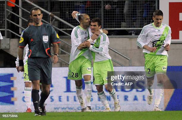 Saint-Etienne's Argentinean forward Gonzalo Rubén Bergessio is congratulated by his teammate Yohan Benalouane after scoring a goal during the French...