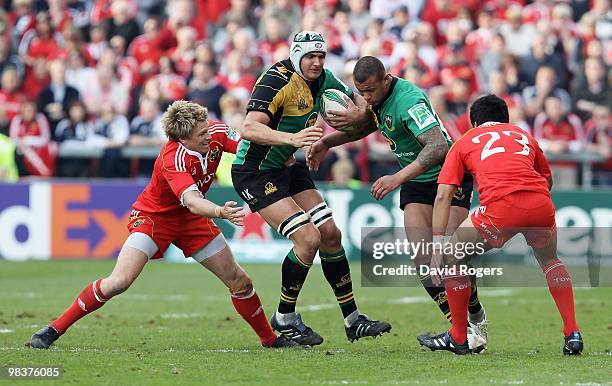 Juandre Kruger of Northampton is tackled by Jean de Villiers during the Heineken Cup quarter final match between Munster and Northampton Saints at...