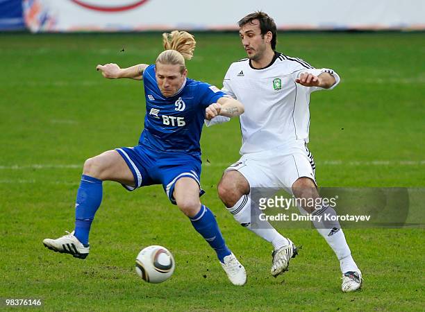 Andriy Voronin of FC Dynamo Moscow battles for the ball with Georgi Dzhioyev of FC Tom Tomsk during the Russian Football League Championship match...