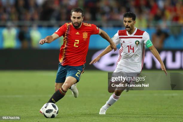 Dani Carvajal of Spain runs with the ball under pressure from Mbark Boussoufa of Morocco during the 2018 FIFA World Cup Russia group B match between...