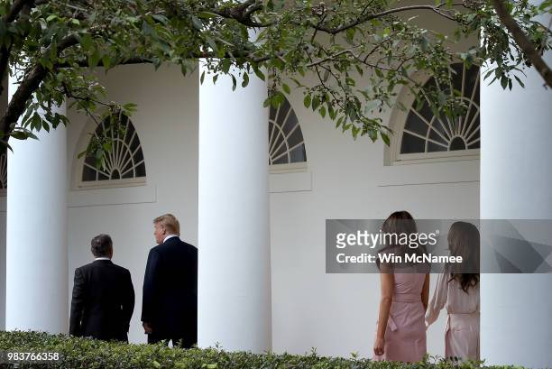 President Donald Trump walks with King Abdullah of Jordan as first lady Melania Trump and Queen Rania follow at the White House June 25, 2018 in...