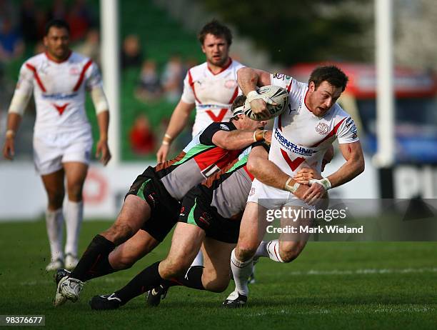 James Roby of St Helens is tackled by the Quins defence during the Engage Super League match between Harlequins and St Helens at The Stoop on April...