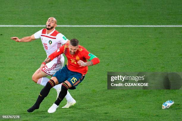 Morocco's forward Noureddine Amrabat vies with Spain's defender Sergio Ramos who looses a sneaker during the Russia 2018 World Cup Group B football...