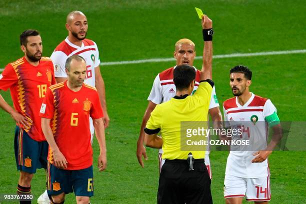 Morocco's midfielder Mbarek Boussoufa is shown a yellow card by Uzbek referee Ravshan Irmatov during the Russia 2018 World Cup Group B football match...
