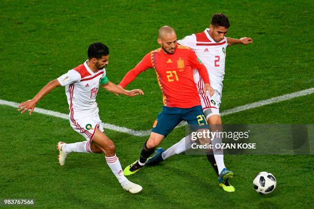 Spain's forward David Silva vies with Morocco's midfielder Mbarek Boussoufa and Morocco's defender Achraf Hakimi during the Russia 2018 World Cup...
