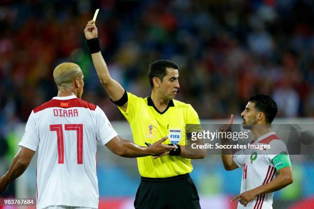 Mbark Boussoufa of Morocco receives a yellow card from referee Ravshan Irmatov during the World Cup match between Spain v Morocco at the Kaliningrad...