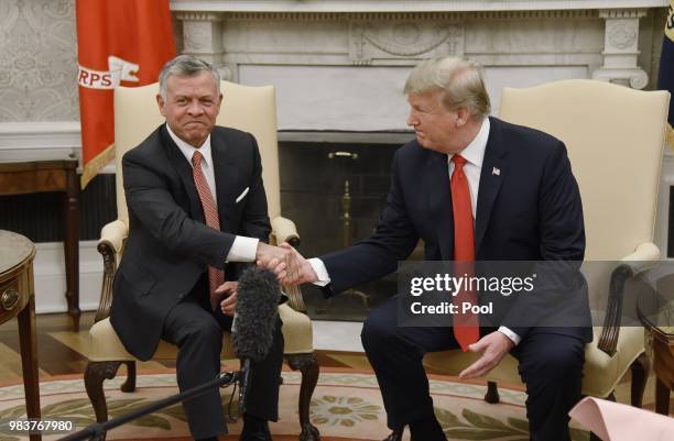 President Donald Trump shakes hands with King Abdullah II during a meeting in the Oval Office of the White House on June 25, 2018 in Washington, DC.