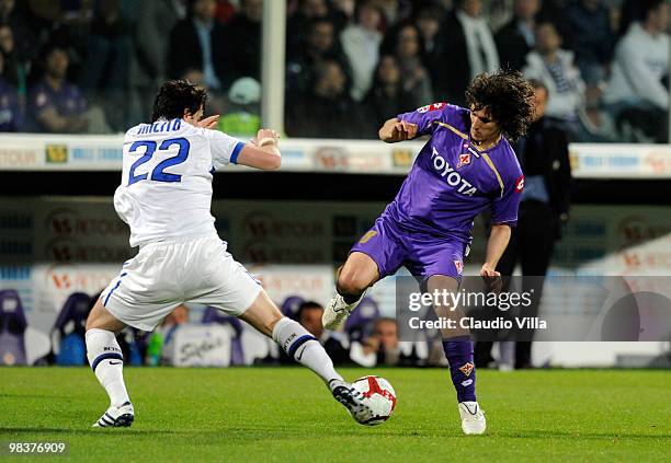 Stevan Jovetic of ACF Fiorentina competes for the ball with Diego Milito of FC Internazionale Milano during the Serie A match between ACF Fiorentina...