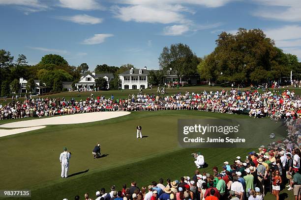 Soren Kjeldsen of Denmark hits a putt on the ninth green as Fred Couples looks on during the third round of the 2010 Masters Tournament at Augusta...