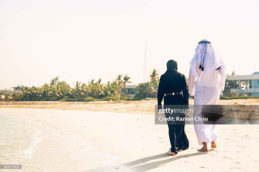 Arabian Couple Walking On The Beach