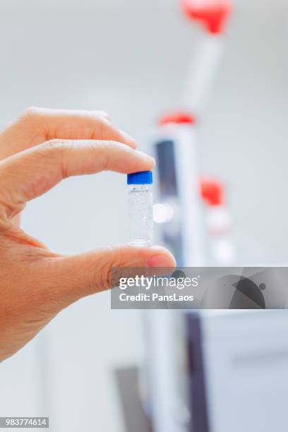 test bottle in hand for medical chemical analysis - advance 2018 exam stock pictures, royalty-free photos & images