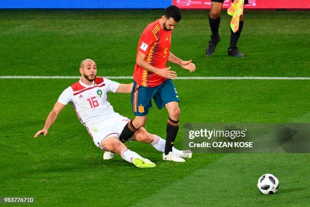 Morocco's forward Noureddine Amrabat vies with Spain's midfielder Sergio Busquets during the Russia 2018 World Cup Group B football match between...