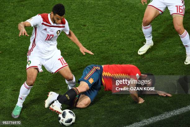 Morocco's midfielder Younes Belhanda vies with Spain's defender Dani Carvajal lying on the ground during the Russia 2018 World Cup Group B football...