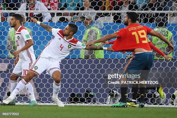 Morocco's defender Manuel Da Costa grabs Spain's forward Diego Costa's jersey during the Russia 2018 World Cup Group B football match between Spain...