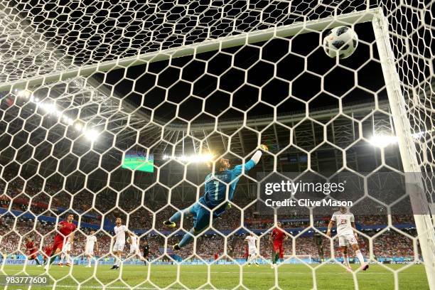 Iran goalkeeper Ali Beiranvand dives in vain as Ricardo Quaresma of Portugal scores his team's first goal during the 2018 FIFA World Cup Russia group...