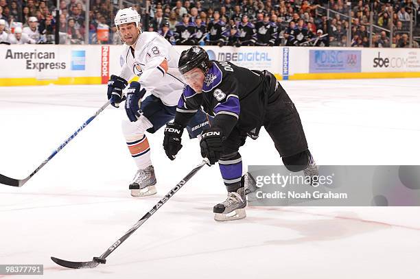 Drew Doughty of the Los Angeles Kings reaches for the puck against Ethan Moreau of the Edmonton Oilers on April 10, 2010 at Staples Center in Los...