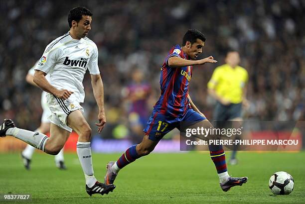 Barcelona's forward Pedro Rodriguez shoots to score next to Real Madrid's defender Alvaro Arbeloa during the 'El Clasico' Spanish League football...