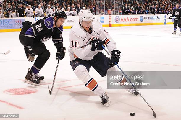 Shawn Horcoff of the Edmonton Oilers skates with the puck against Alexander Frolov of the Los Angeles Kings on April 10, 2010 at Staples Center in...