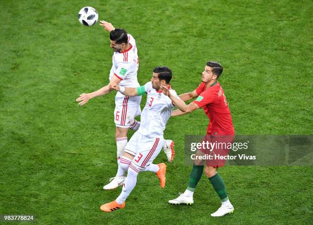 Saeid Ezatolahi of Iran clears the ball under pressure from Andre Silva of Portugal during the 2018 FIFA World Cup Russia group B match between Iran...