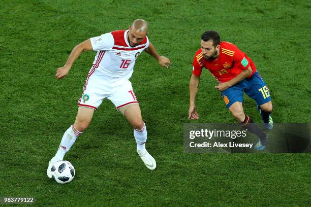 Noureddine Amrabat of Morocco is challenged by Jordi Alba of Spain during the 2018 FIFA World Cup Russia group B match between Spain and Morocco at...