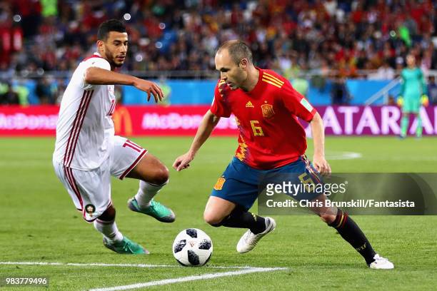 Andres Iniesta of Spain and Younes Belhanda of Morocco in action during the 2018 FIFA World Cup Russia group B match between Spain and Morocco at...