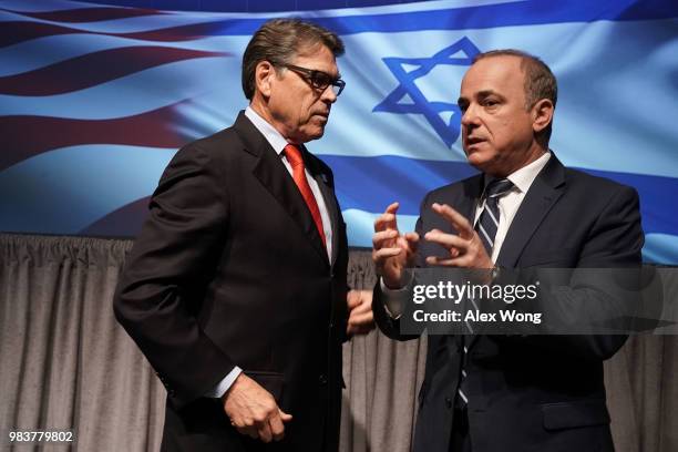 Secretary of Energy Rick Perry talks to Israeli Minister of National Infrastructure, Energy and Water Resources Yuval Steinitz after a lunch event at...