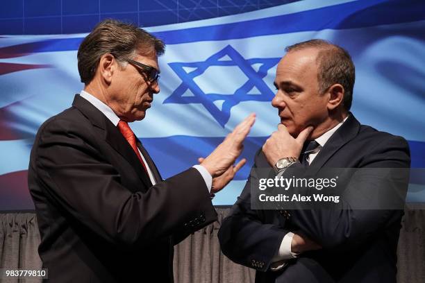 Secretary of Energy Rick Perry talks to Israeli Minister of National Infrastructure, Energy and Water Resources Yuval Steinitz after a lunch event at...