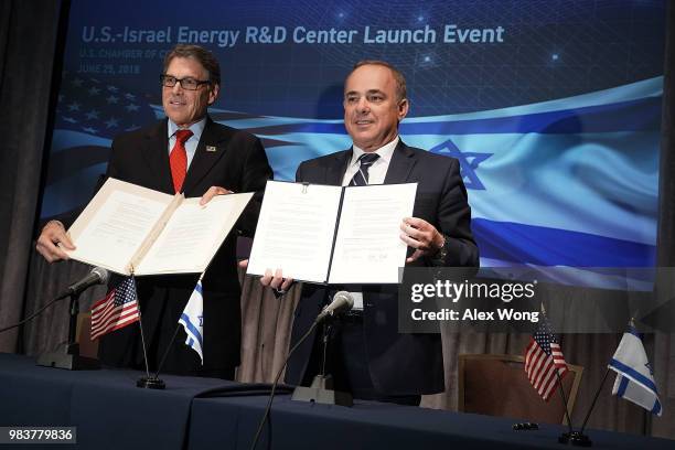 Secretary of Energy Rick Perry and Israeli Minister of National Infrastructure, Energy and Water Resources Yuval Steinitz hold up copies of an...