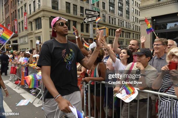 John Henson of the Milwaukee Bucks high fives crowds during the NYC Pride Parade on June 24, 2018 in New York City, New York. NOTE TO USER: User...