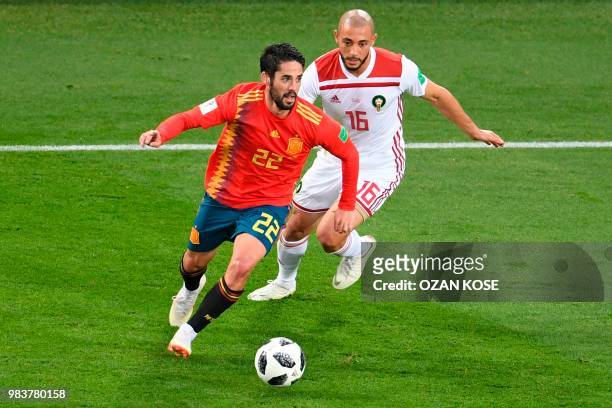 Spain's midfielder Isco vies with Morocco's forward Noureddine Amrabat during the Russia 2018 World Cup Group B football match between Spain and...