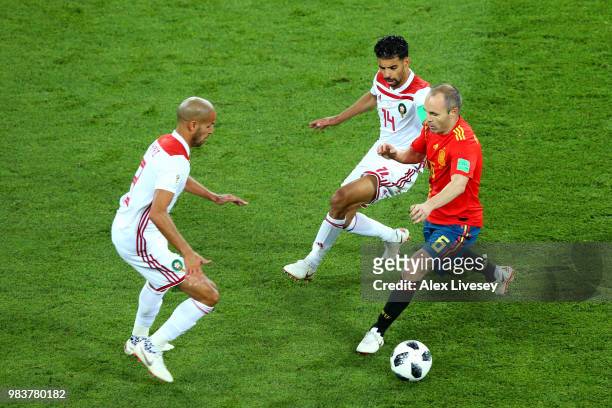 Andres Iniesta of Spain is challenged by Mbark Boussoufa of Morocco during the 2018 FIFA World Cup Russia group B match between Spain and Morocco at...