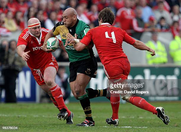 Soane Tonga'huia of Northampton charges forward past John Hayes and Donncha O'Callaghan during the Heineken Cup quarter final match between Munster...