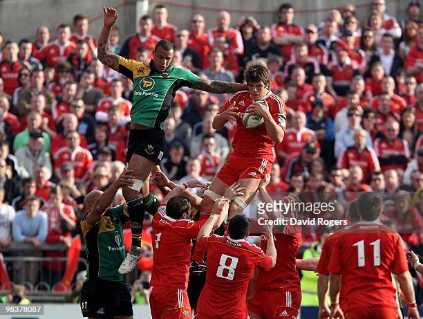 Donncha O'Callaghan of Munster beats Courtney Lawes to the lineout ball during the Heineken Cup quarter final match between Munster and Northampton...