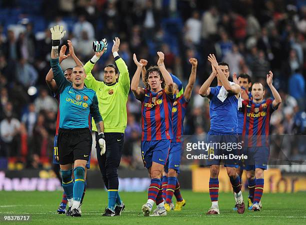 Victor Valdes and Carles Puyol of Barcelona celebrate after Barcelona beat Real Madrid 2-0 in the La Liga match between Real Madrid and Barcelona at...