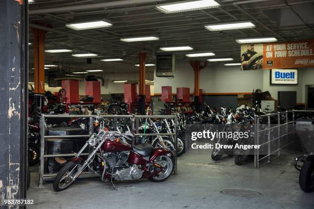 Motorcycles sit inside the service garage of the Harley-Davidson of New York City showroom store, June 25, 2018 in the Queens borough of New York...