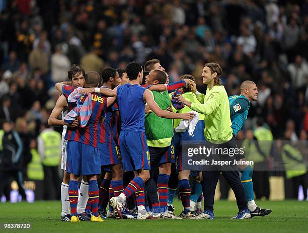 Barcelona players celebrate as team captain Raul Gonzalez of Real Madrid embraces Daniel Alves of FC Barcelona at the end of the La Liga match...