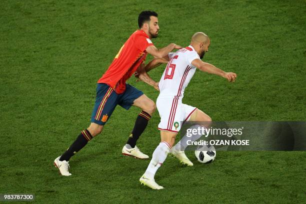 Spain's midfielder Sergio Busquets vies with Morocco's forward Noureddine Amrabat during the Russia 2018 World Cup Group B football match between...