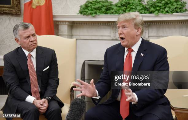 President Donald Trump, right, speaks as King Abdullah II of Jordan, listens during a meeting in the Oval Office of the White House in Washington,...