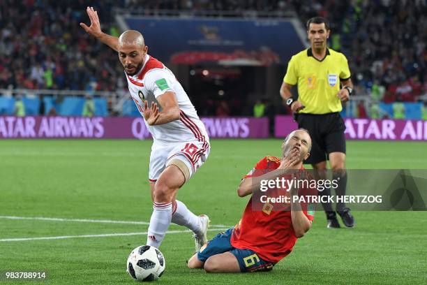 Morocco's forward Noureddine Amrabat vies with Spain's midfielder Andres Iniesta during the Russia 2018 World Cup Group B football match between...