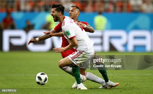 Ricardo Quaresma of Portugal fouls Saeid Ezatolahi of Iran lies on the pitch injured during the 2018 FIFA World Cup Russia group B match between Iran...