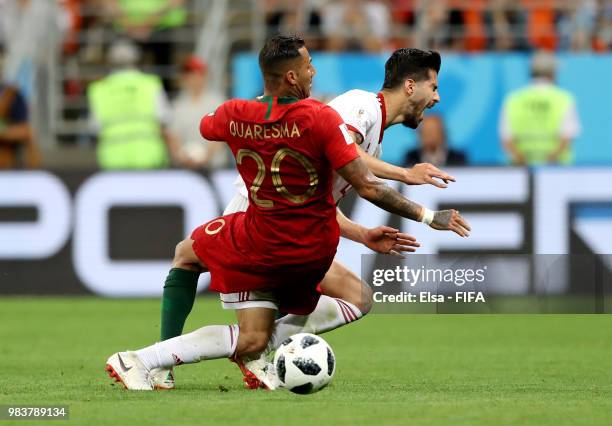 Ricardo Quaresma of Portugal fouls Saeid Ezatolahi of Iran lies on the pitch injured during the 2018 FIFA World Cup Russia group B match between Iran...