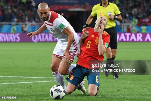 Morocco's forward Noureddine Amrabat vies with Spain's midfielder Andres Iniesta during the Russia 2018 World Cup Group B football match between...