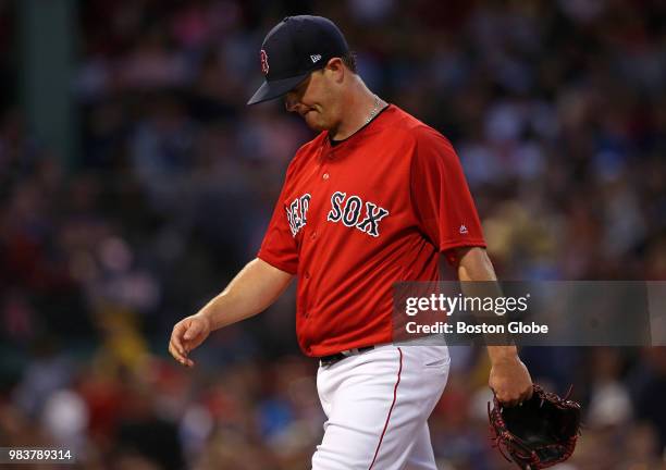 Boston Red Sox starting pitcher Steven Wright heads off the field after handing off the ball during the fourth inning. The Boston Red Sox host the...