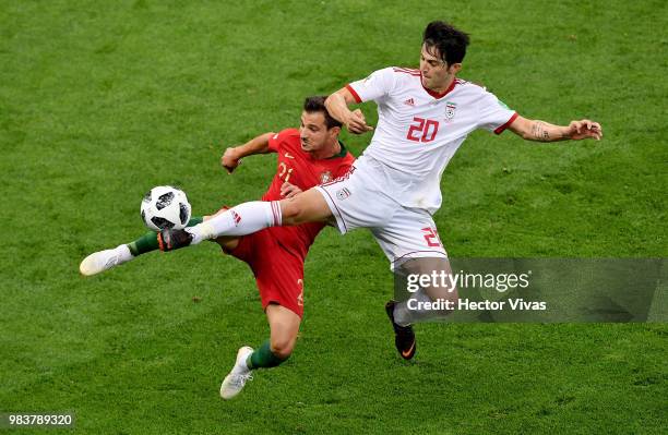 Sardar Azmoun of Iran challenge for the ball with Cedric of Portugal during the 2018 FIFA World Cup Russia group B match between Iran and Portugal at...