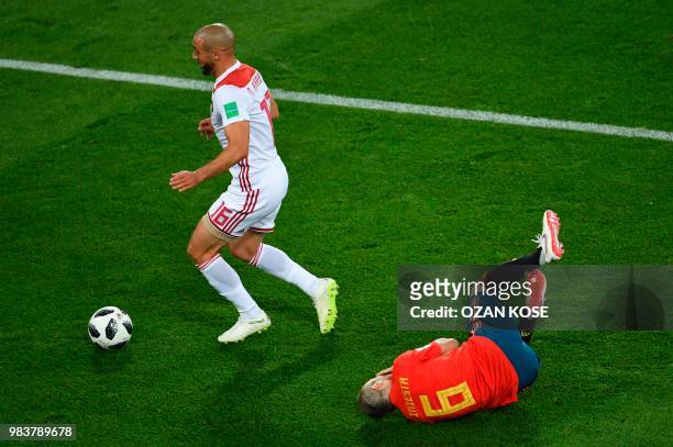 Spain's midfielder Andres Iniesta reacts past Morocco's forward Noureddine Amrabat during the Russia 2018 World Cup Group B football match between...