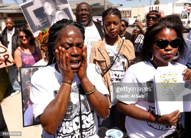 Lisa Hines, left, Mother of Wakiesha Wilson, a black woman who was found dead in a LAPD jail in 2016, wipes tears as she speaks during a Black Lives...