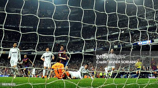 Barcelona's Argentinian forward Lionel Messi scores during the 'El Clasico' Spanish League football match Real Madrid against Barcelona at the...