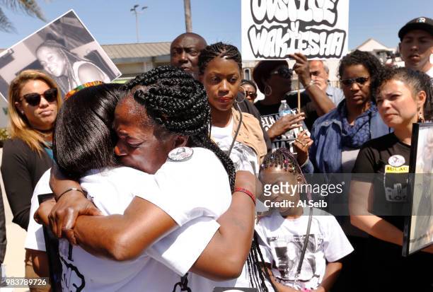 Lisa Hines, right, Mother of Wakiesha Wilson, a black woman who was found dead in a LAPD jail in 2016, hugs her sister Sheila Hines-Brim, left,...