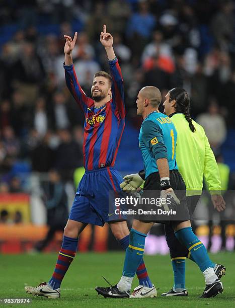 Gerard Pique of Barcelona celebrates beside Victor Valdes after beating Real Madrid 2-0 in the La Liga match between Real Madrid and Barcelona at the...